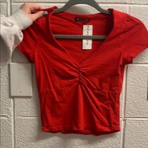 Brandy Melville Red top. Never worn- tag still on!